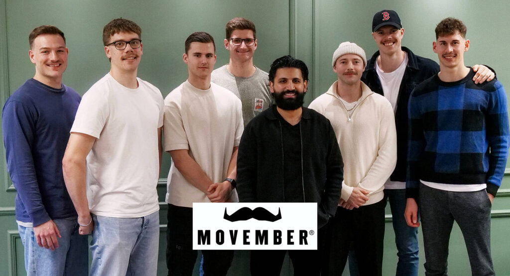 Das Bild zeigt 8 Männer, manche sind Spieler der HSG. Es soll auf das Thema Movember aufmerksam gemacht werden.