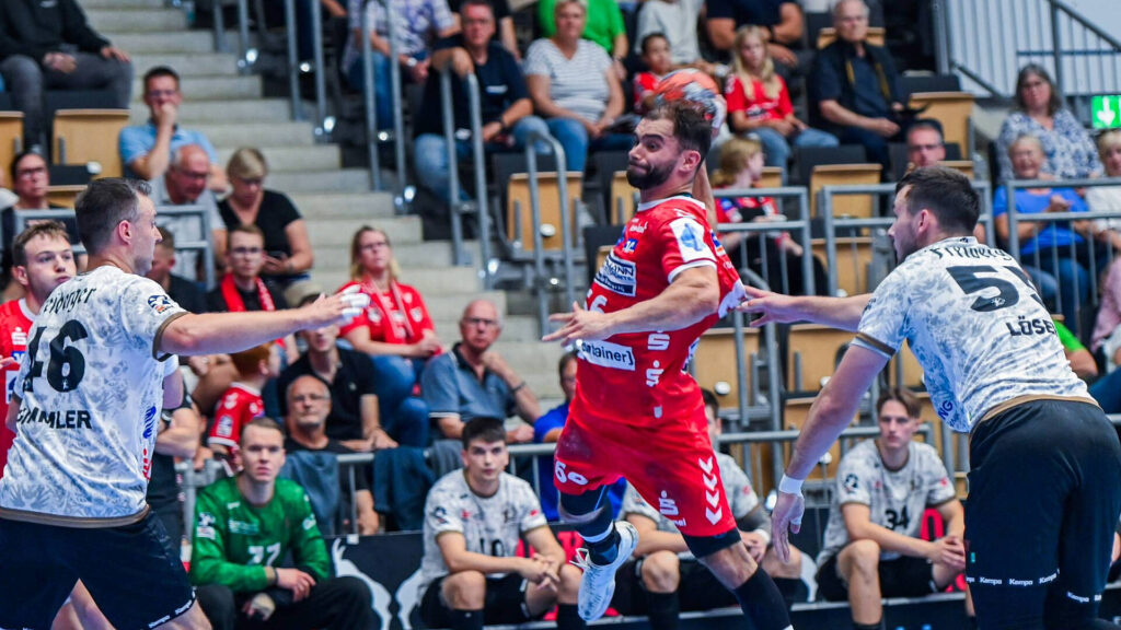 Das Bild zeigt einen HSG Spieler der grade einen Wurf tätigt.